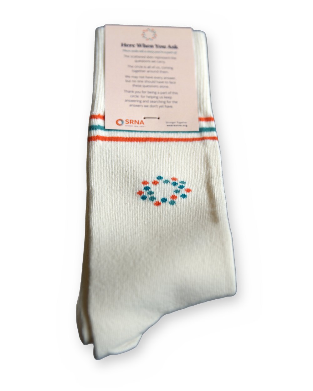 A folded pair of Care Socks with the &ldquo;Here When You Ask&rdquo; card that comes with them.